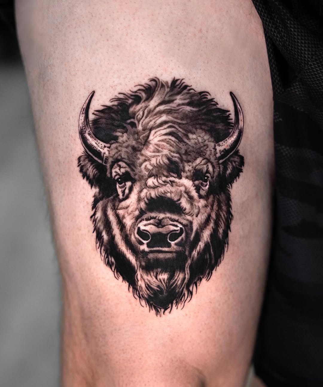 This striking bison tattoo captures the creature's powerful presence with intricate details.