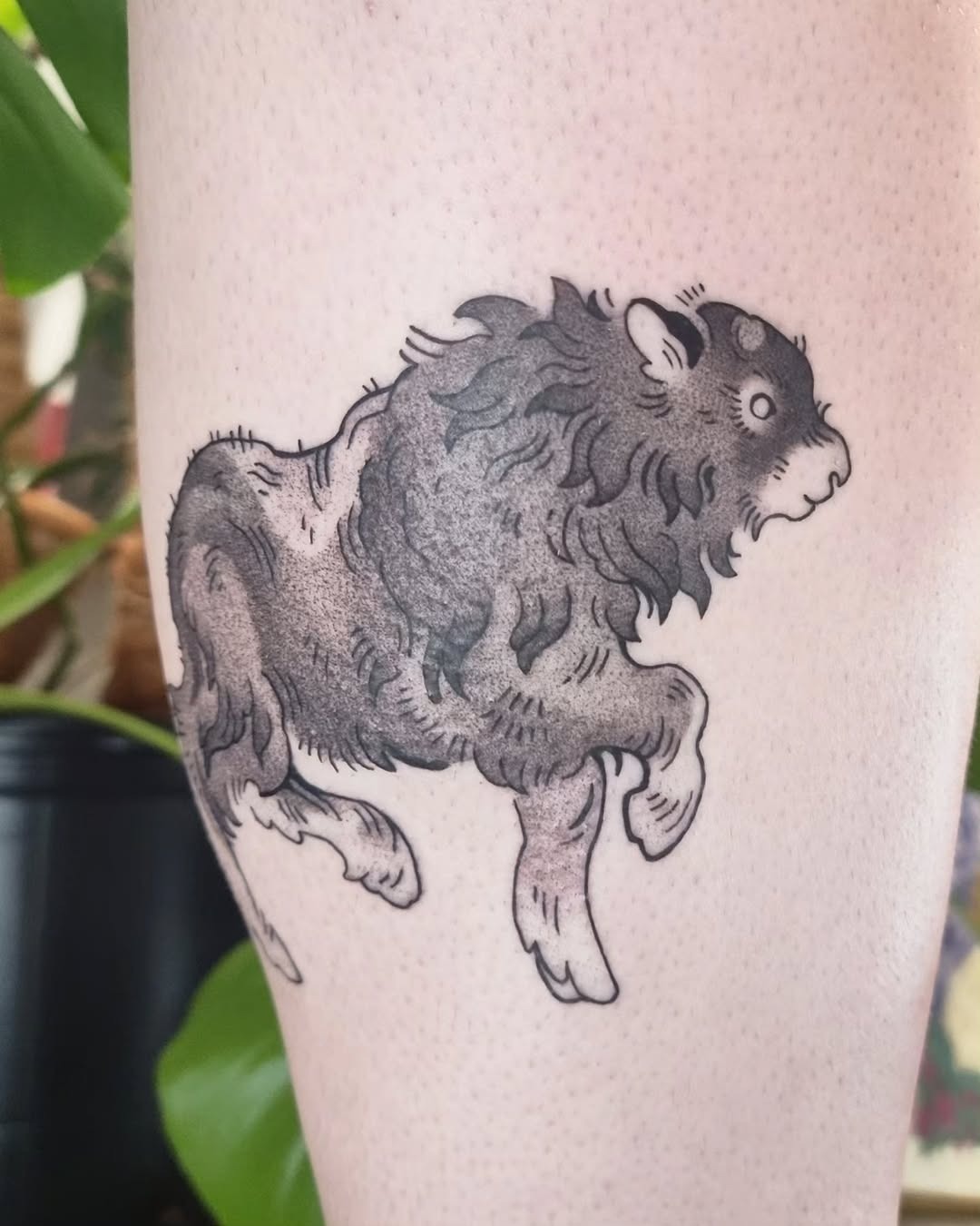 This tattoo showcases a bison in a lively running pose, embodying strength and freedom.