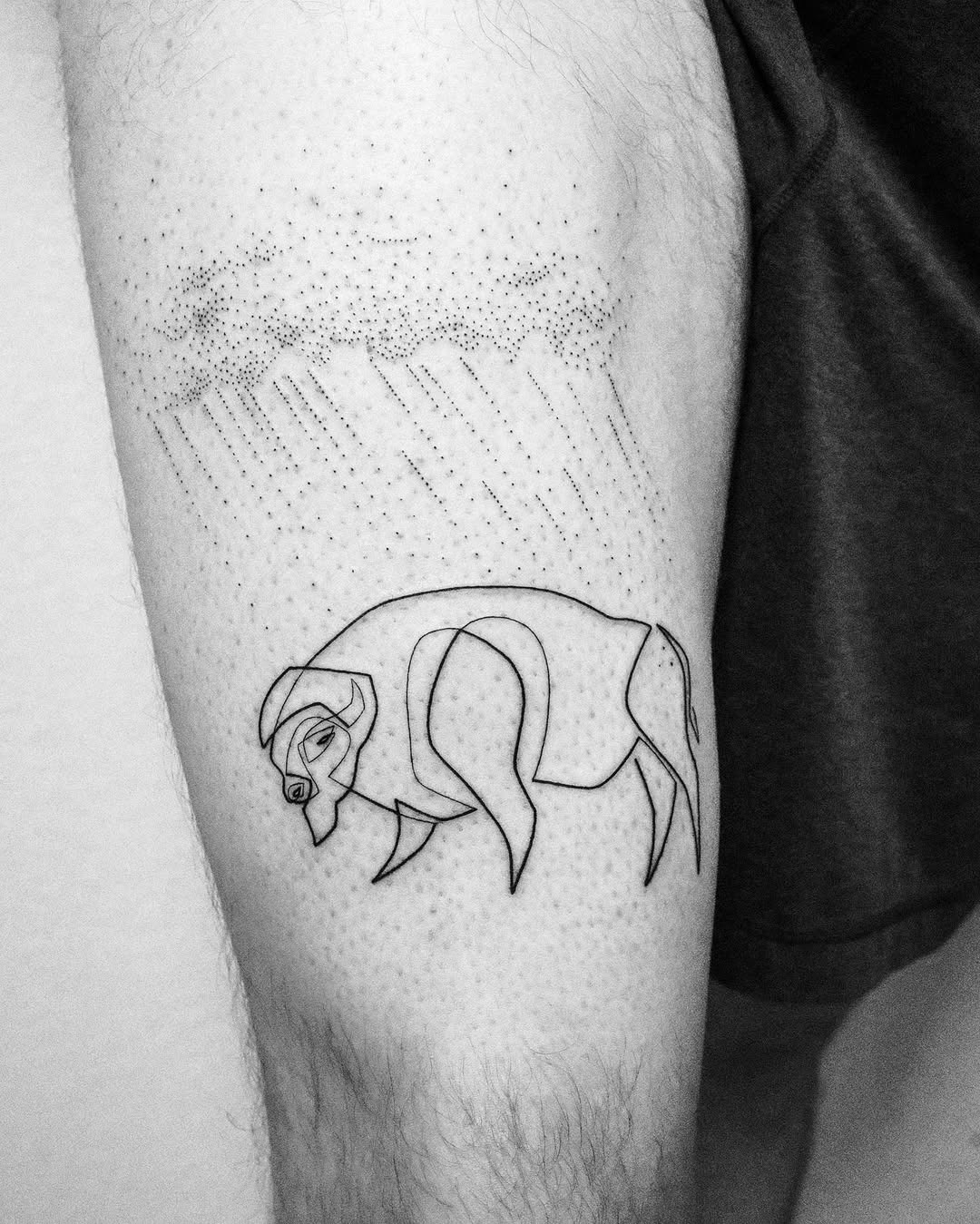 This tattoo features a beautifully minimalist bison design, crafted with fine lines and a touch of shading.