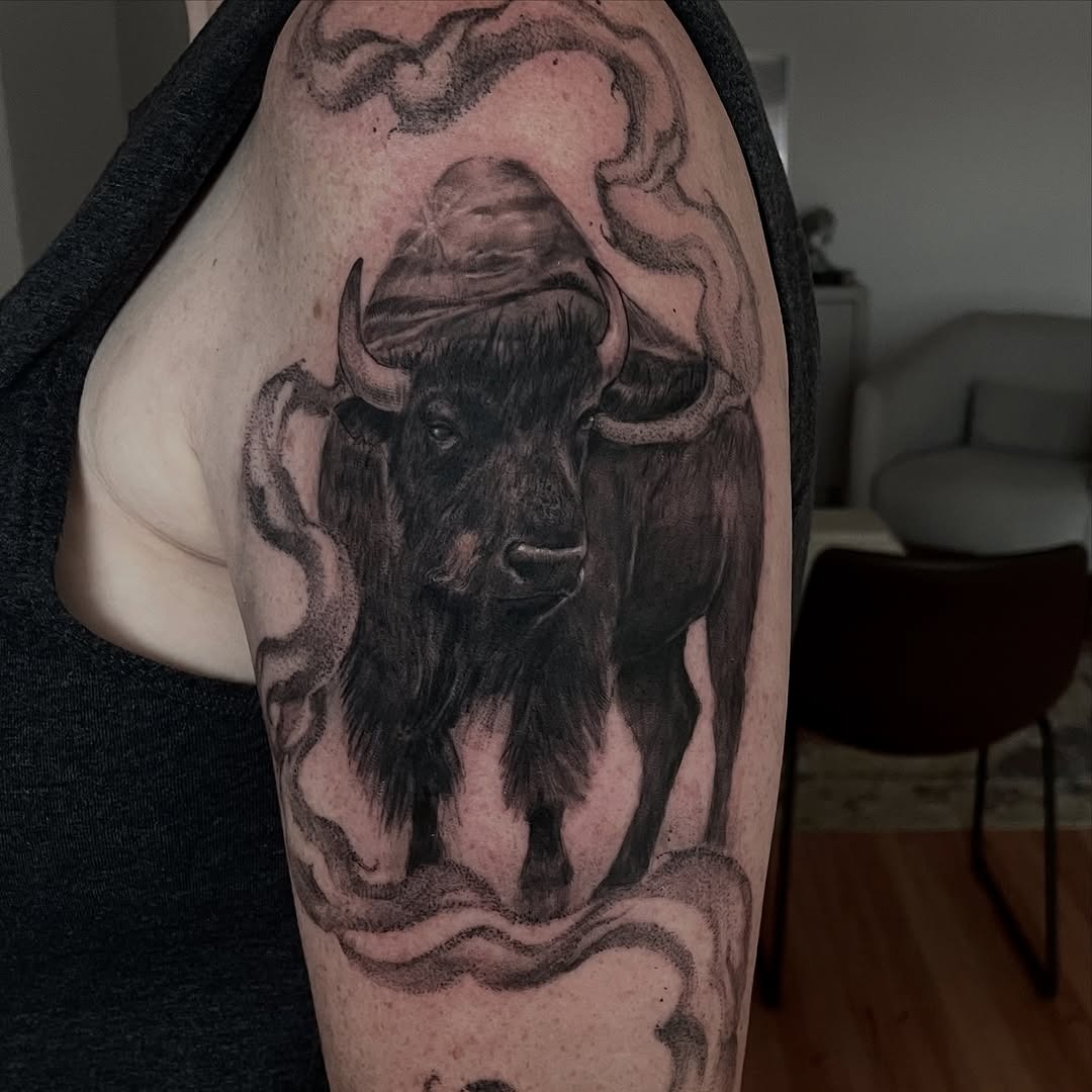 This bison tattoo showcases a strikingly realistic portrait, with detailed shading that brings the animal to life.