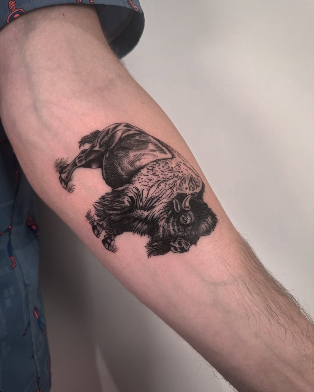 This bison tattoo captures the majesty of the animal with intricate blackwork detailing.