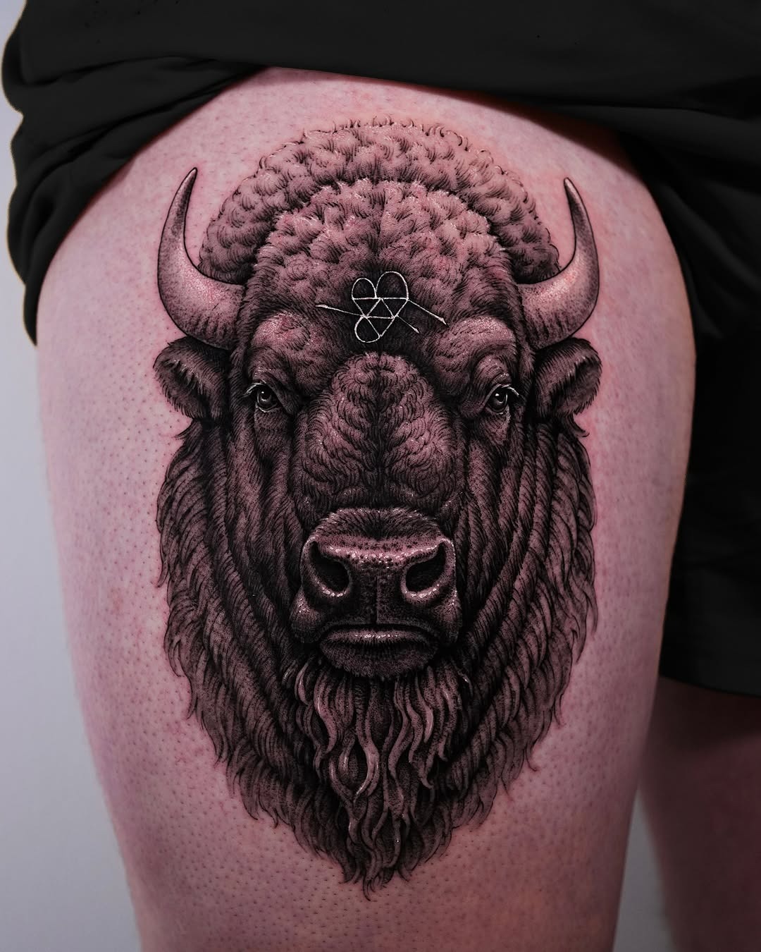 This impressive bison tattoo showcases incredible detail, highlighting its textured fur and fierce expression.