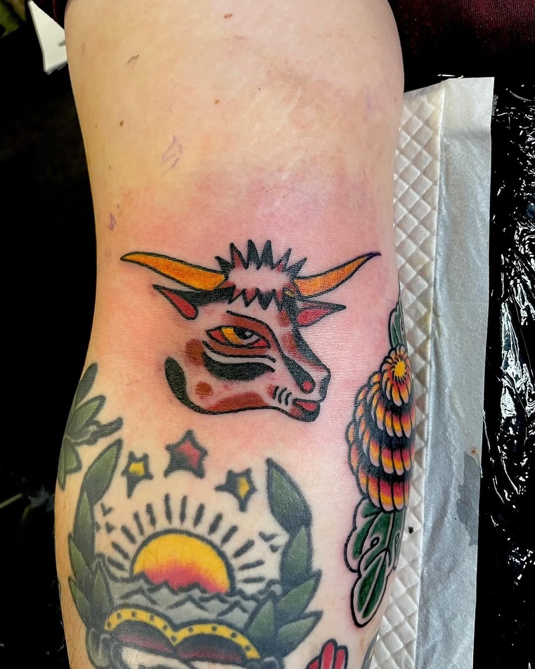This bison tattoo features a striking design with bold colors and sharp lines.