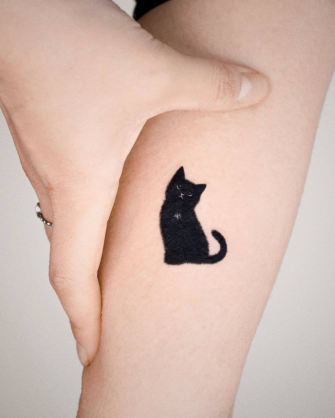 Charming black cat tattoo design on arm Tattoo Design