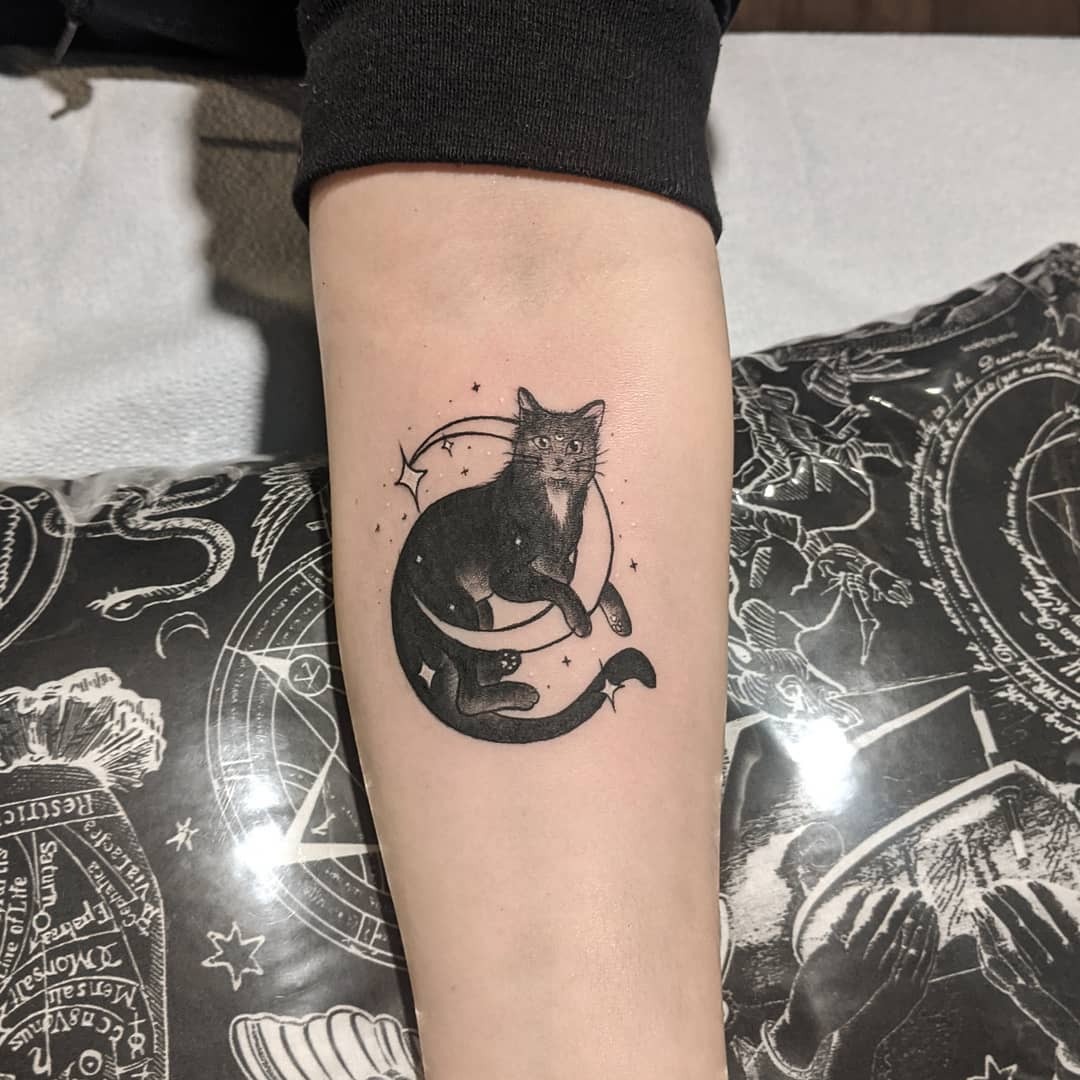 Charming black cat tattoo with celestial elements Tattoo Design