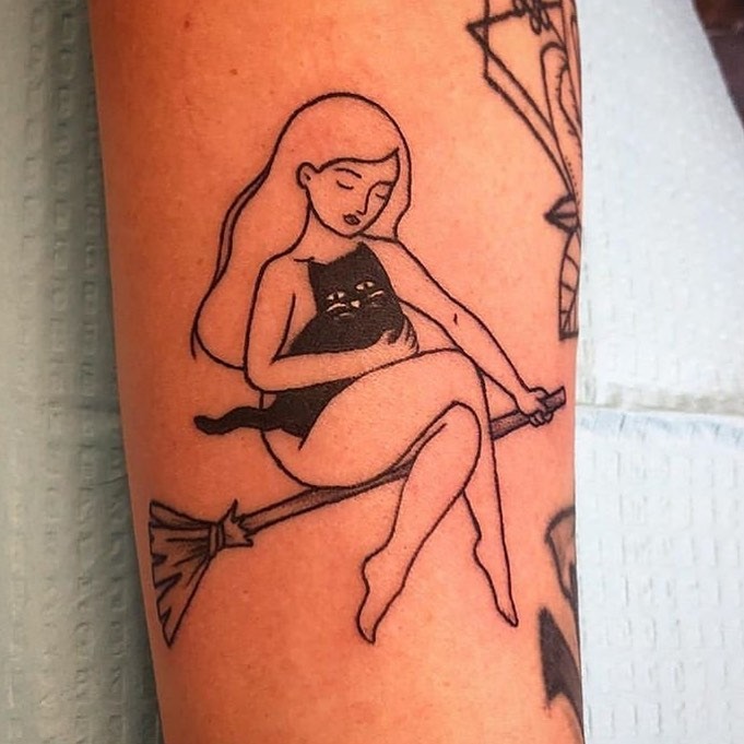 Charming cat tattoo on a witch’s broomstick Tattoo Design