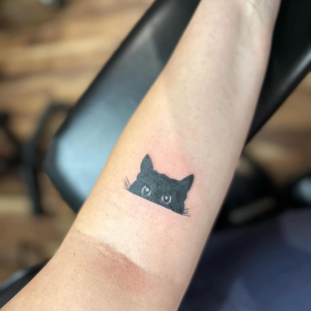 Charming minimalist black cat tattoo design Tattoo Design
