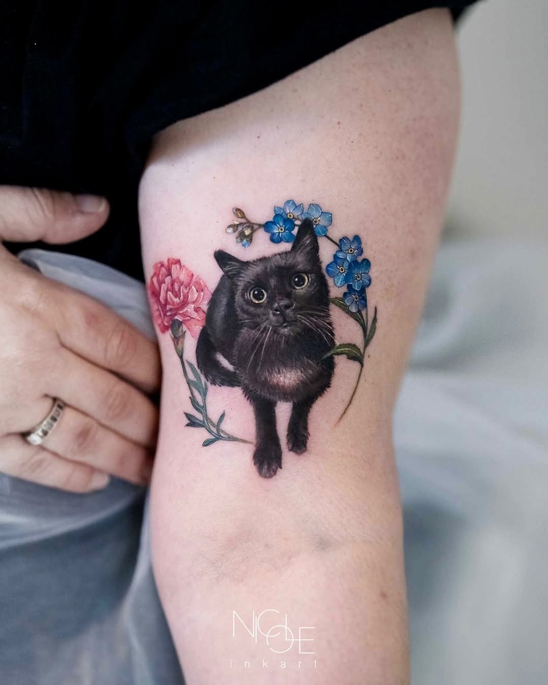 Charming realistic black cat with floral accents Tattoo Design