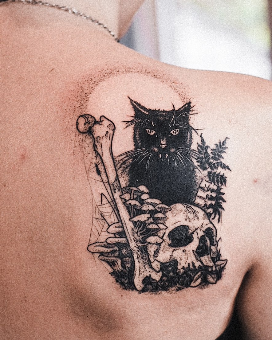 Eerie Black Cat with Skull and Bone Tattoo Tattoo Design