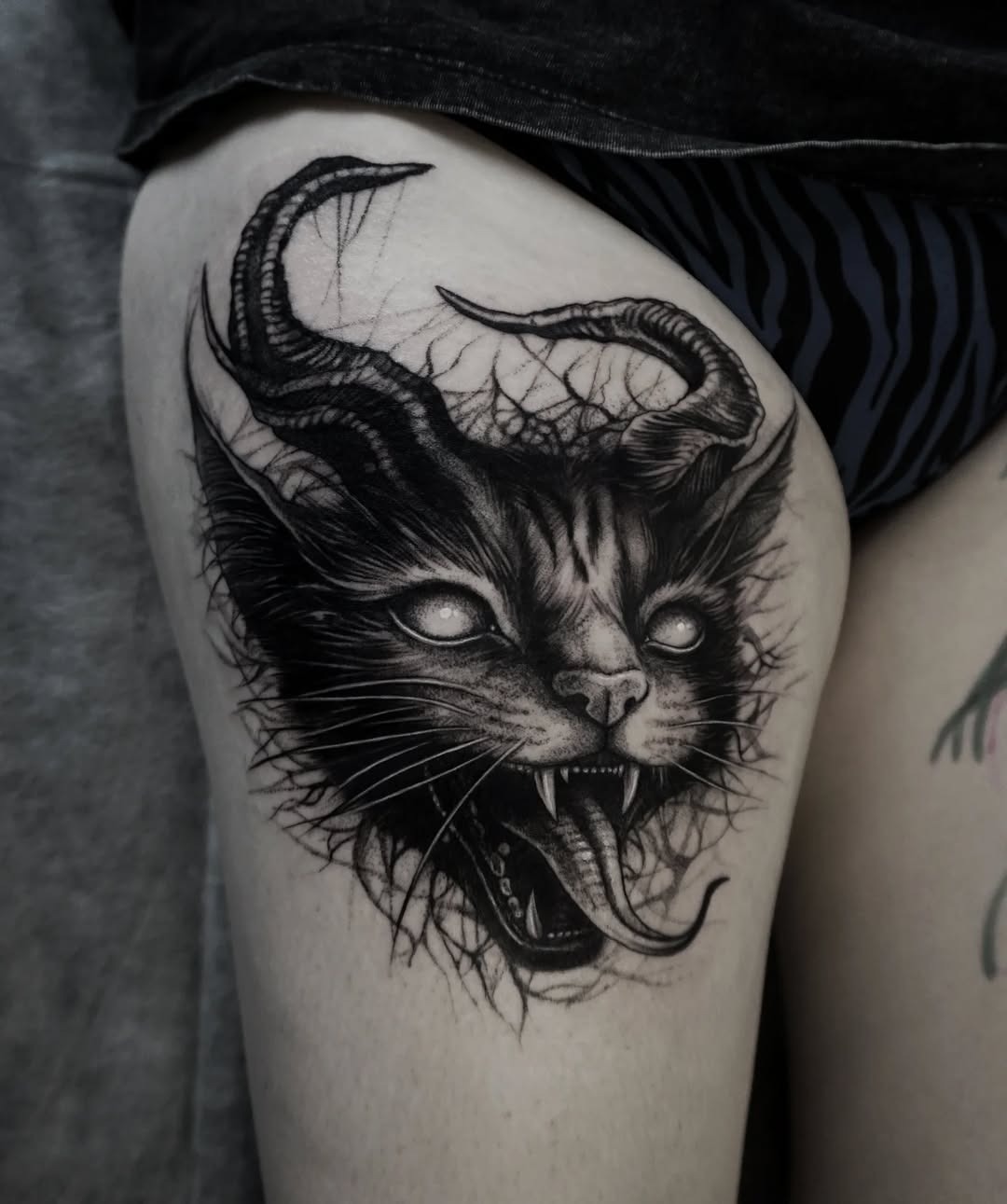 Intricate black cat with mystical horns tattoo Tattoo Design
