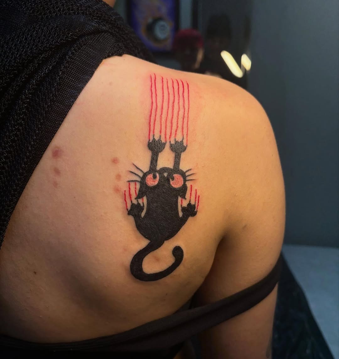 Unique black cat tattoo with striking red claws Tattoo Design