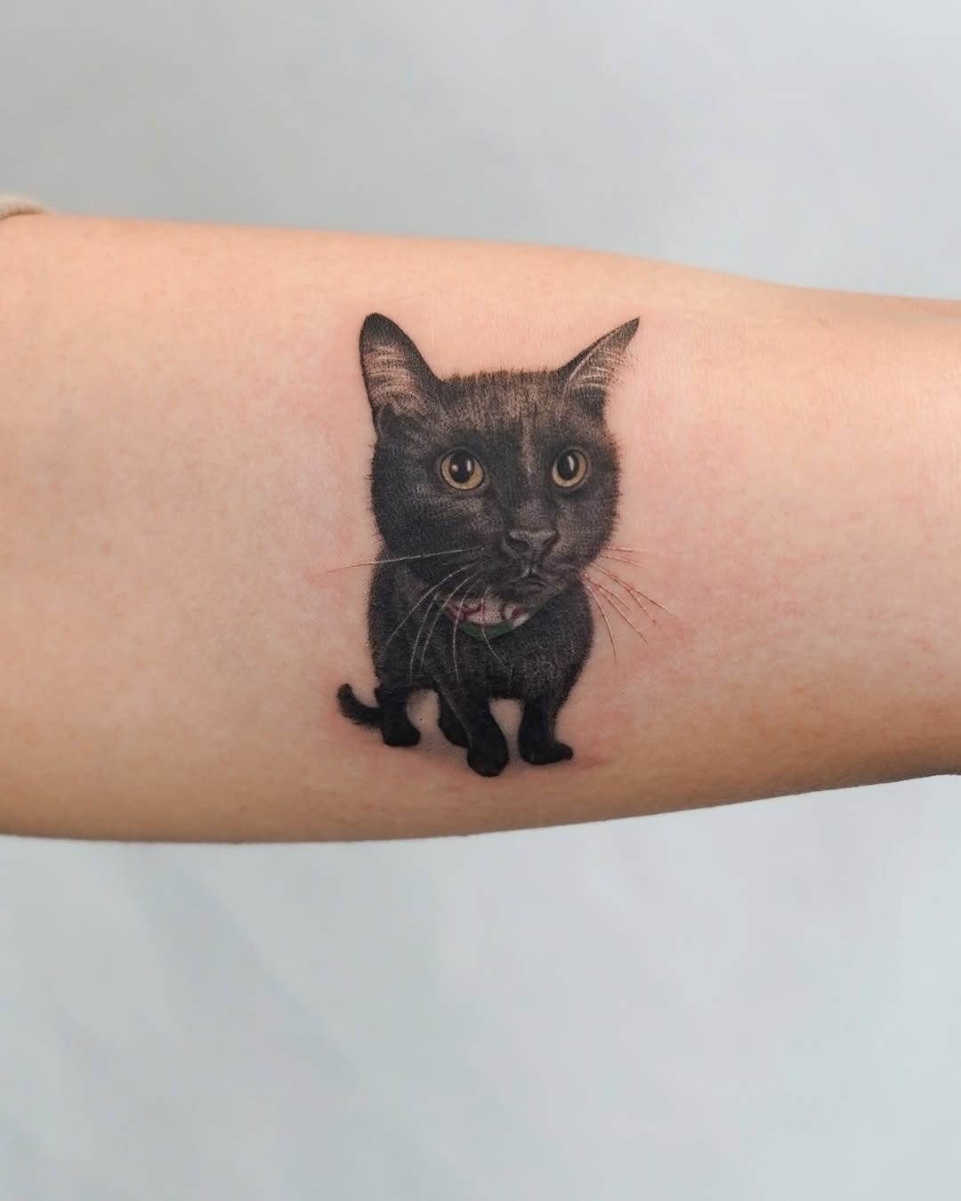 Whimsical black cat tattoo with realistic details Tattoo Design
