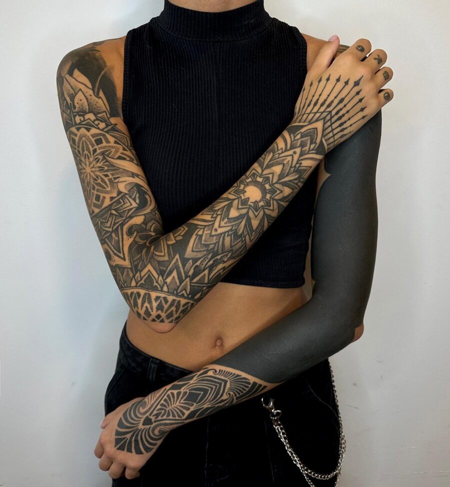 This image showcases stylish black sleeve tattoos combining geometric and floral designs.