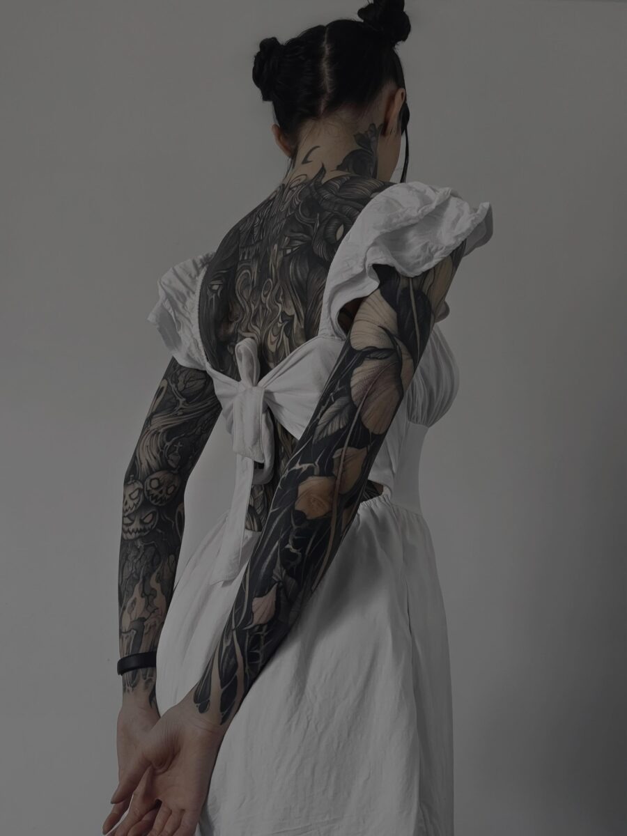 This stunning black sleeve tattoo features intricate designs with a blend of organic and dark elements.