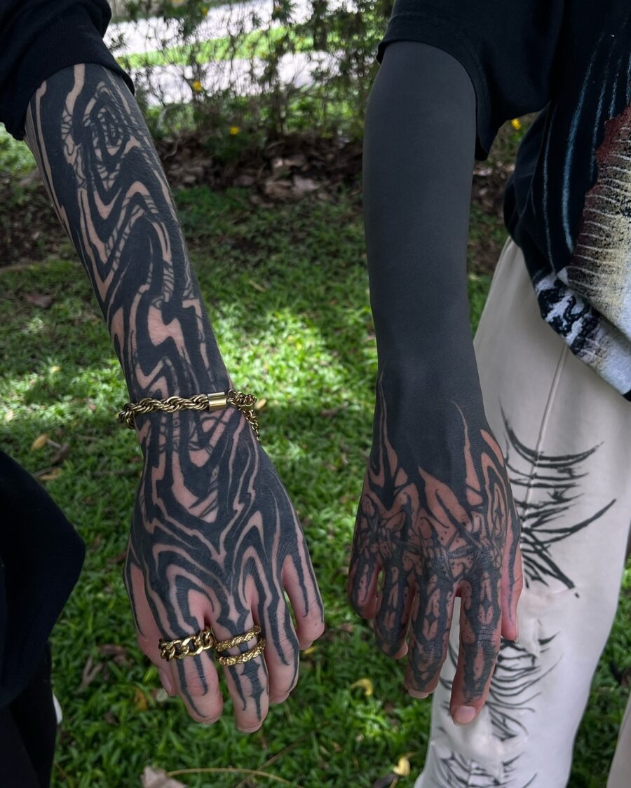 This image features two stunning black sleeve tattoos that exhibit unique abstract designs.