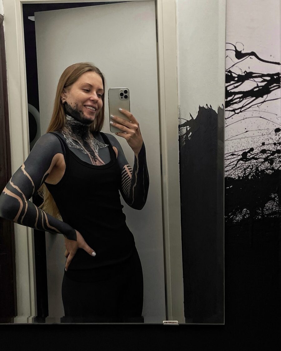 This striking black sleeve tattoo showcases intricate designs and bold patterns.