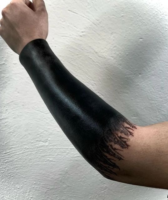 Nature-Inspired Blackout Sleeve Tattoo Design