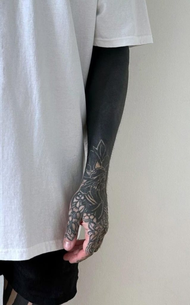 Sleek and Subtle Blackout Forearm Tattoo Design