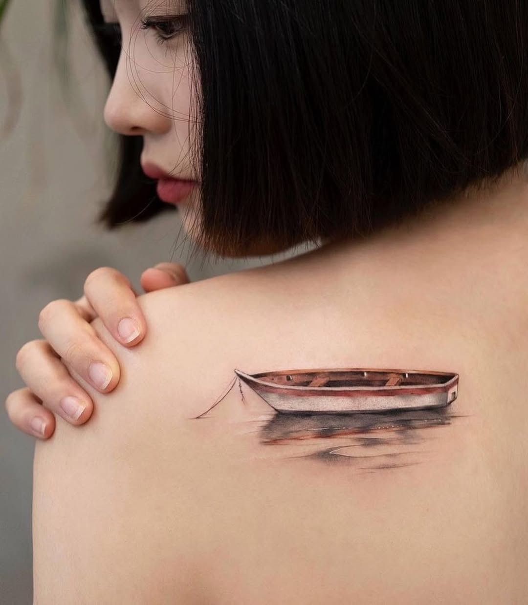 A serene boat tattoo on the shoulder Tattoo Design