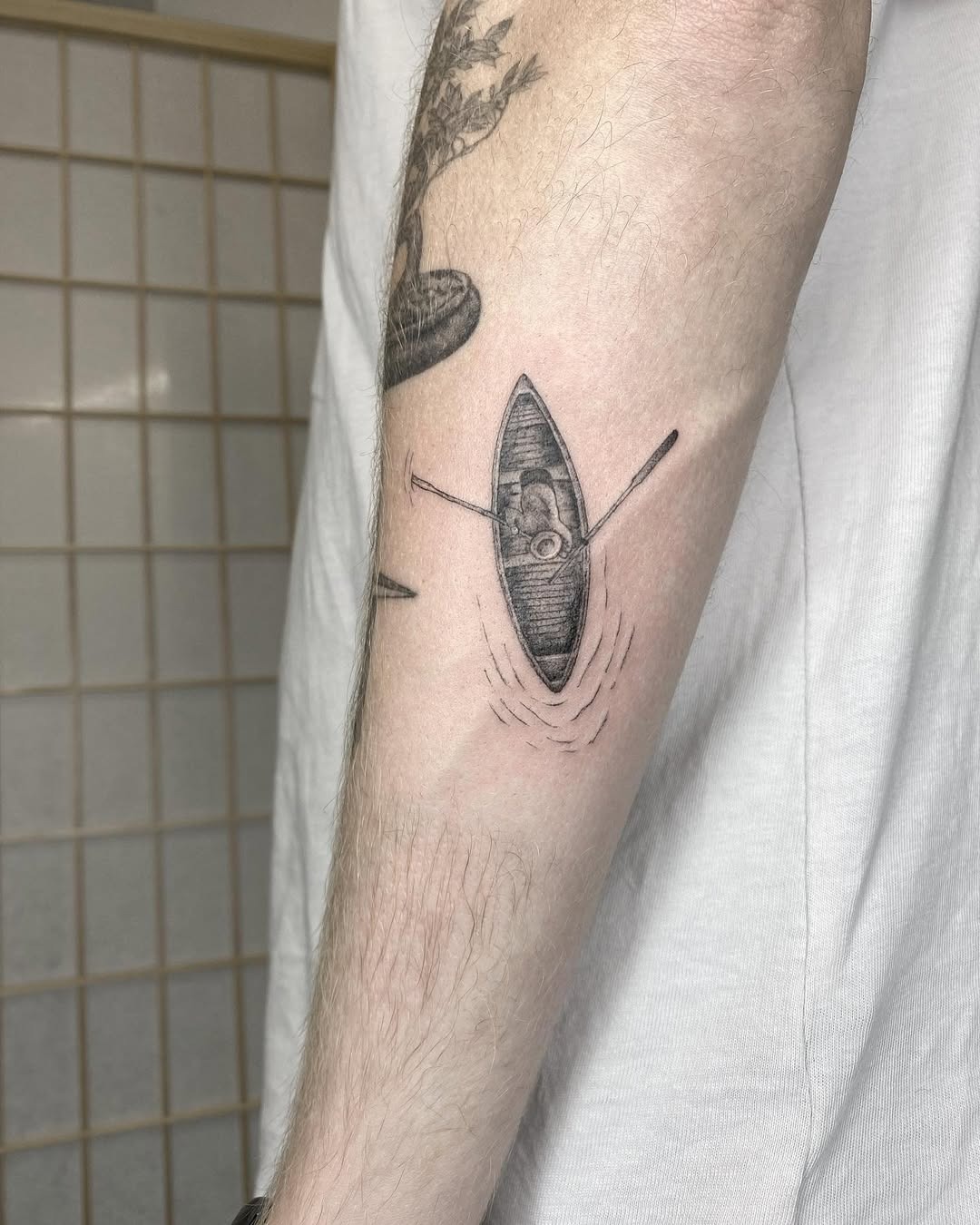A unique kayak tattoo with serene vibes Tattoo Design