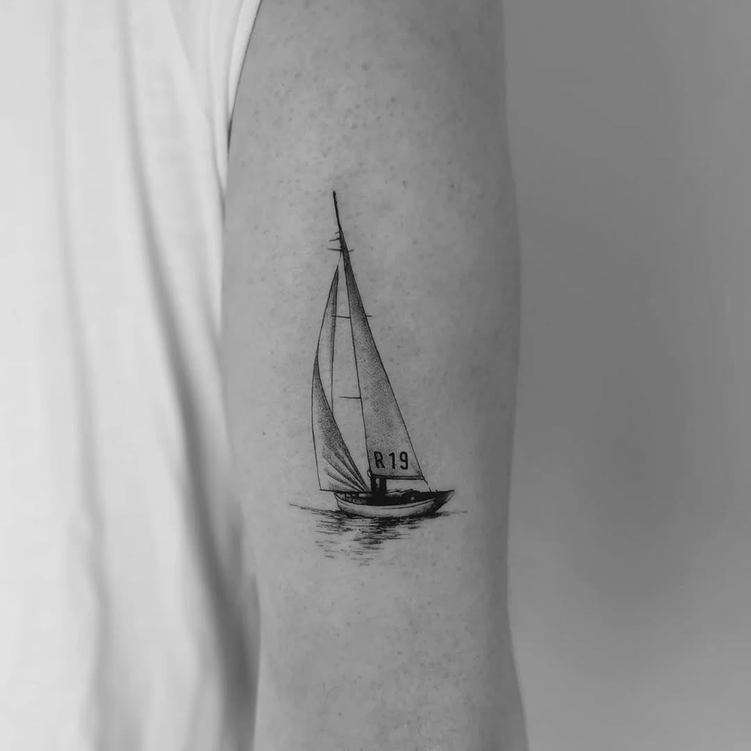Elegant sailboat tattoo on the forearm Tattoo Design