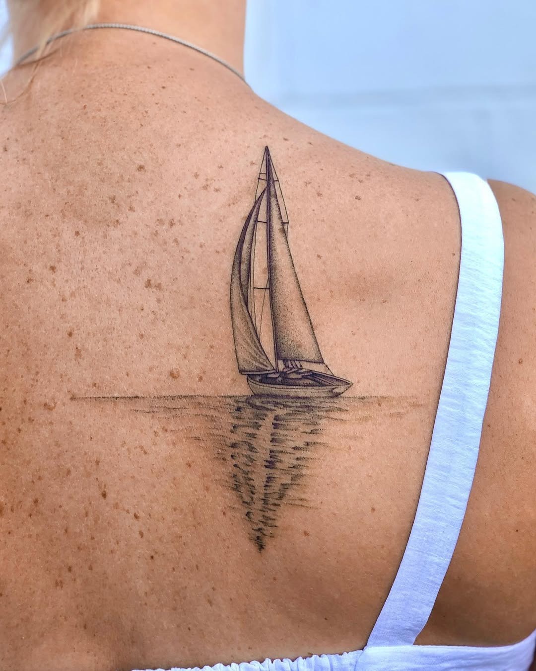 Elegant sailboat tattoo with serene waves Tattoo Design