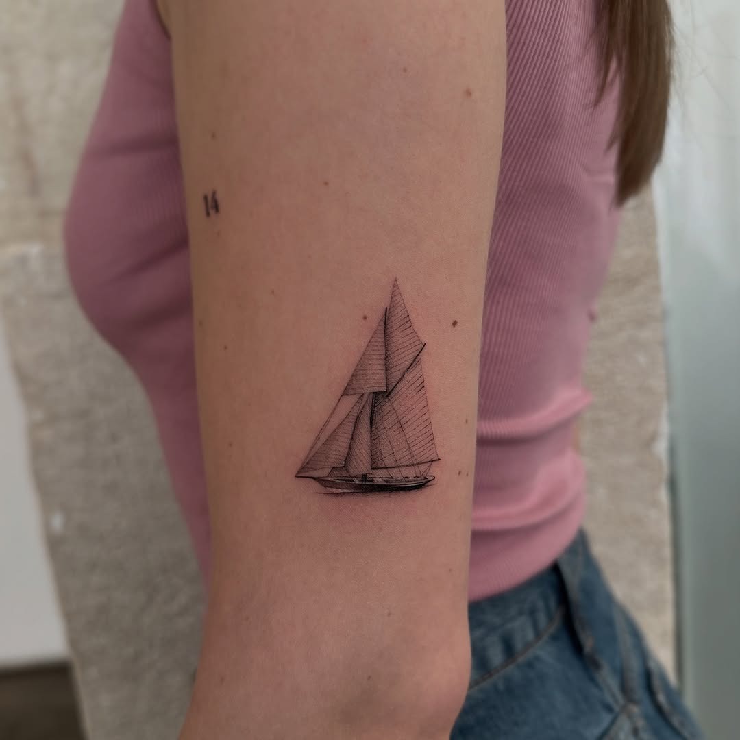 Elegant sailing boat tattoo on forearm. Tattoo Design