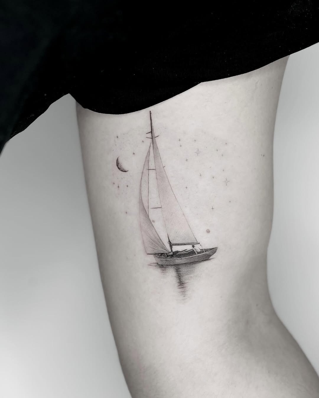 Elegant sailing tattoo with celestial elements Tattoo Design