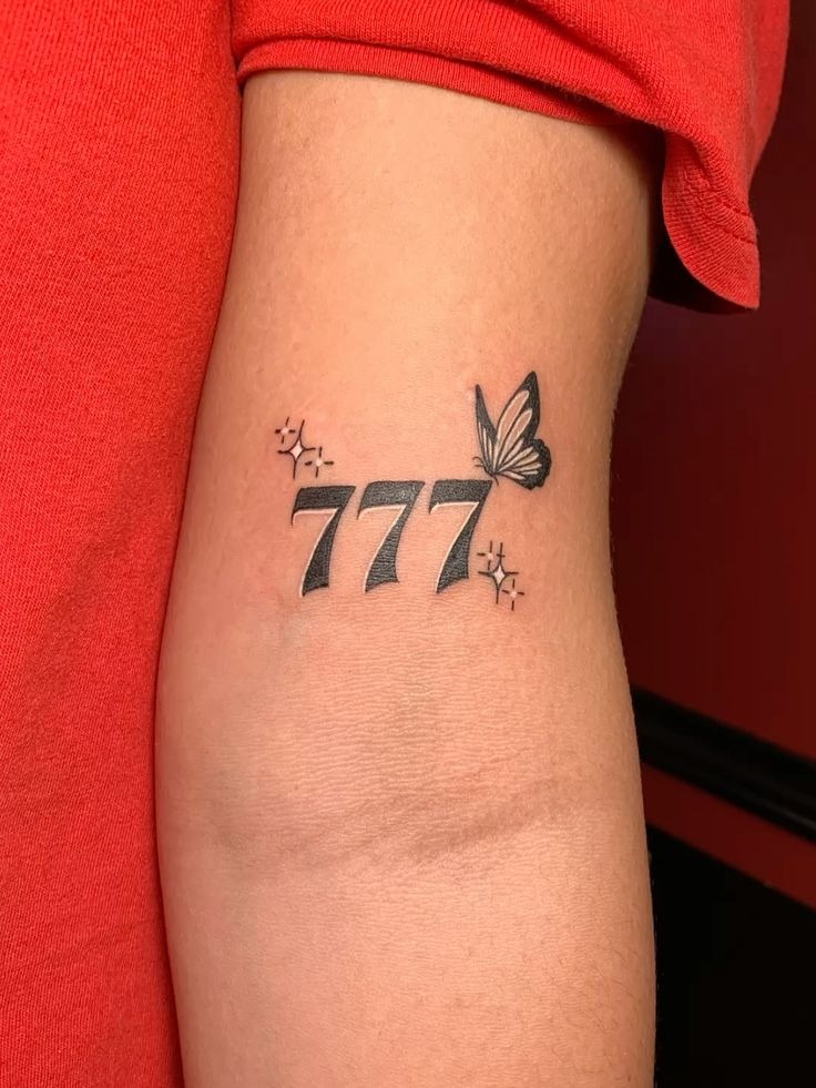 777 and Butterfly Elbow Tattoo, a tattoo design rendered in clean detailed linework.