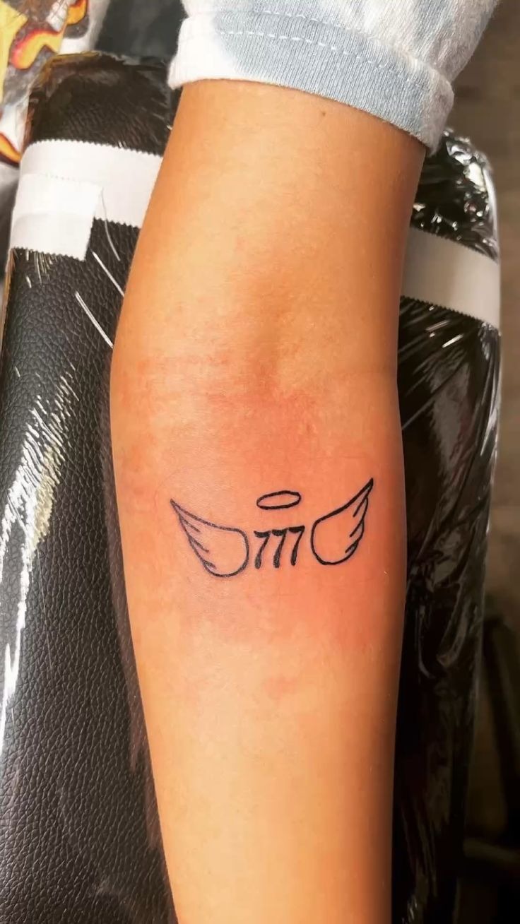 Angel Number with Wings Tattoo, a tattoo design rendered in clean detailed linework.