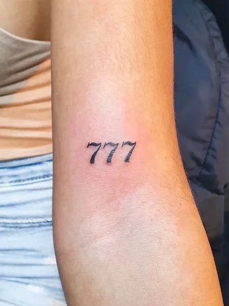 Minimalist Fine Line 777, a tattoo design rendered in clean detailed linework.