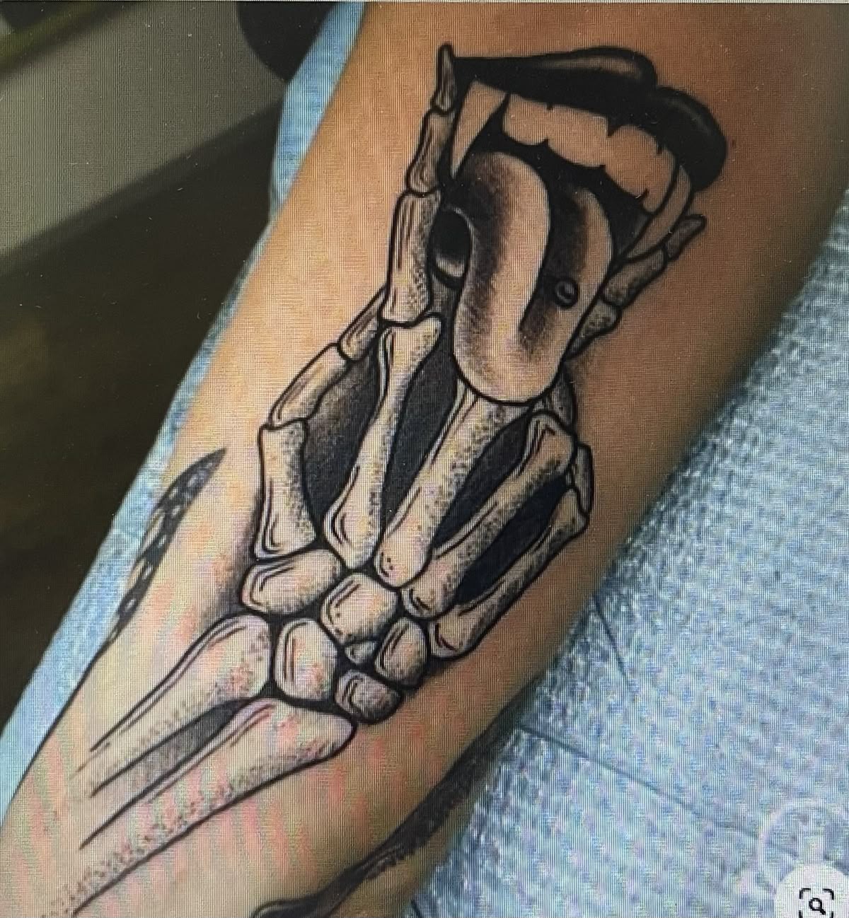 Skeleton Hand Holding Heart Tattoo Design