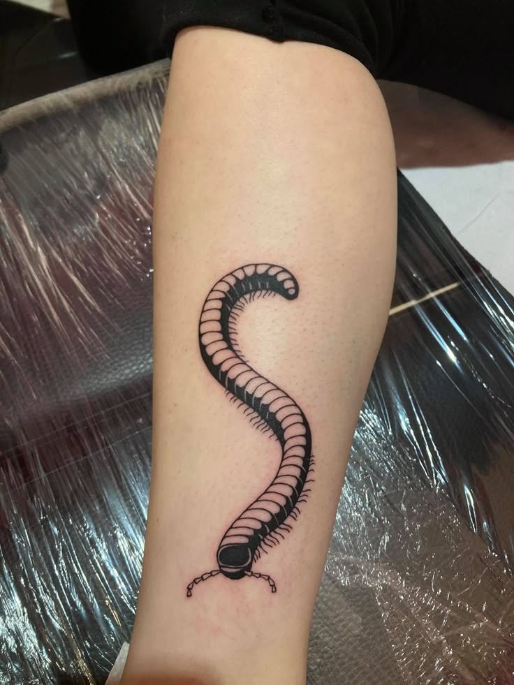 Minimal Curl with Maximum Personality Tattoo Design