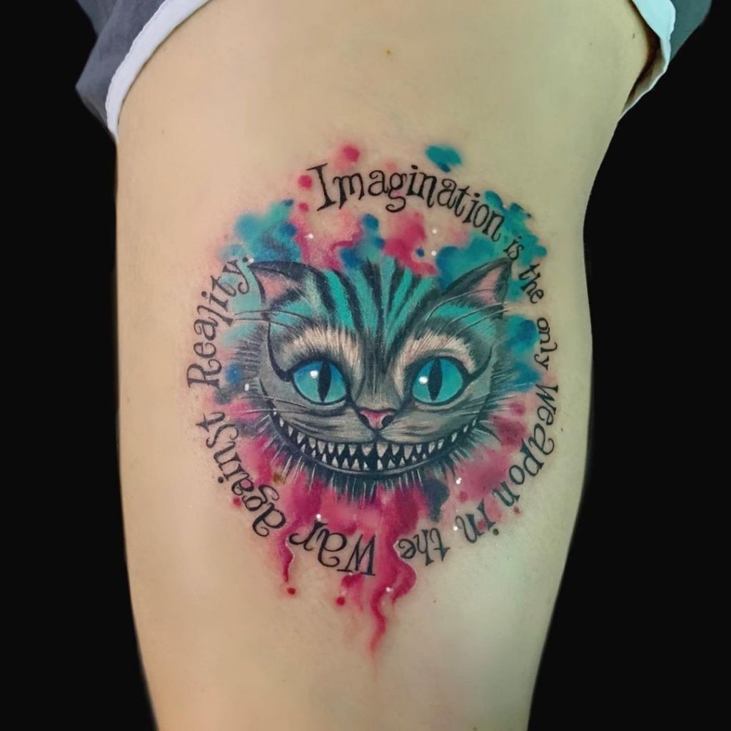 Incorporating the Cheshire Cat's head within a circle of text, this design features the quote: "Imagination is the only weapon in the war against reality." The soft watercolor backdrop is a blend of pinks and blues, creating a dreamlike effect that echoes the fantastical nature of Wonderland.