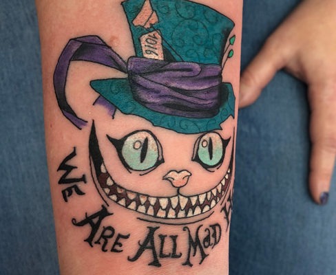 In this whimsical design, the Cheshire Cat dons the iconic Mad Hatter's top hat, a nod to both characters from the Wonderland universe.