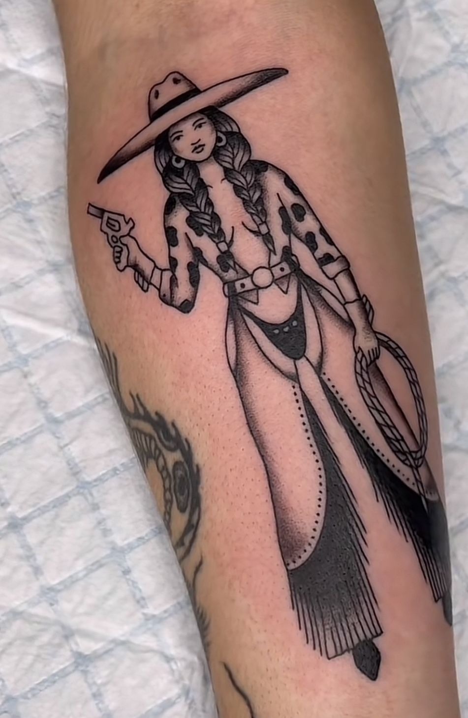 Braided Cowgirl With a Revolver Tattoo Design