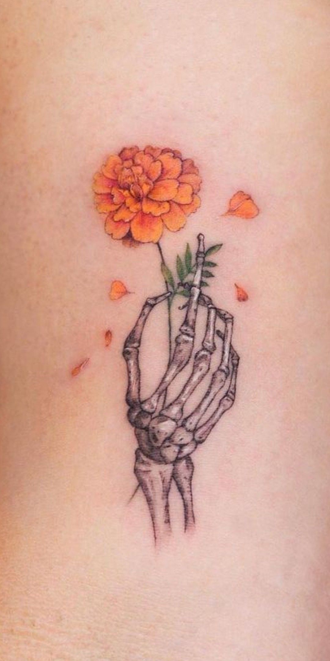 Skeleton Hand Holding A Marigold Tattoo Design