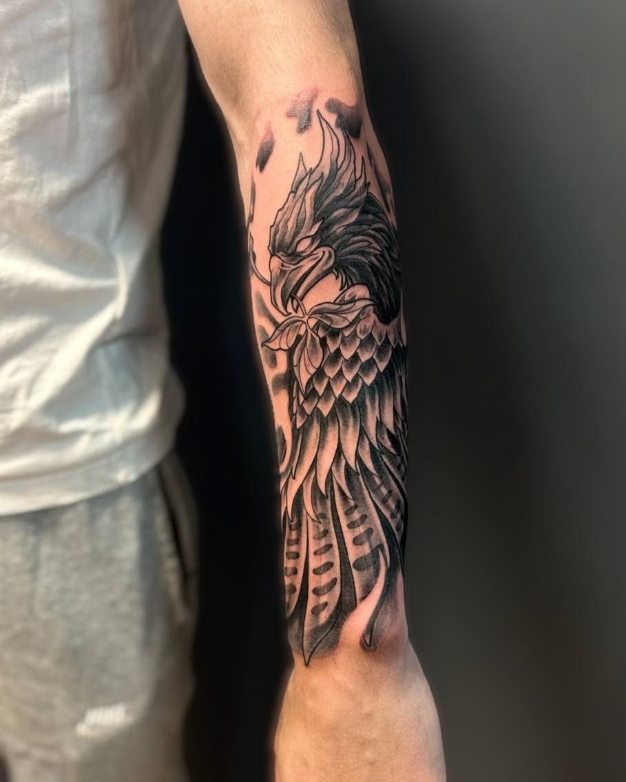 Eagle With Flowing Feather Shapes Tattoo Design