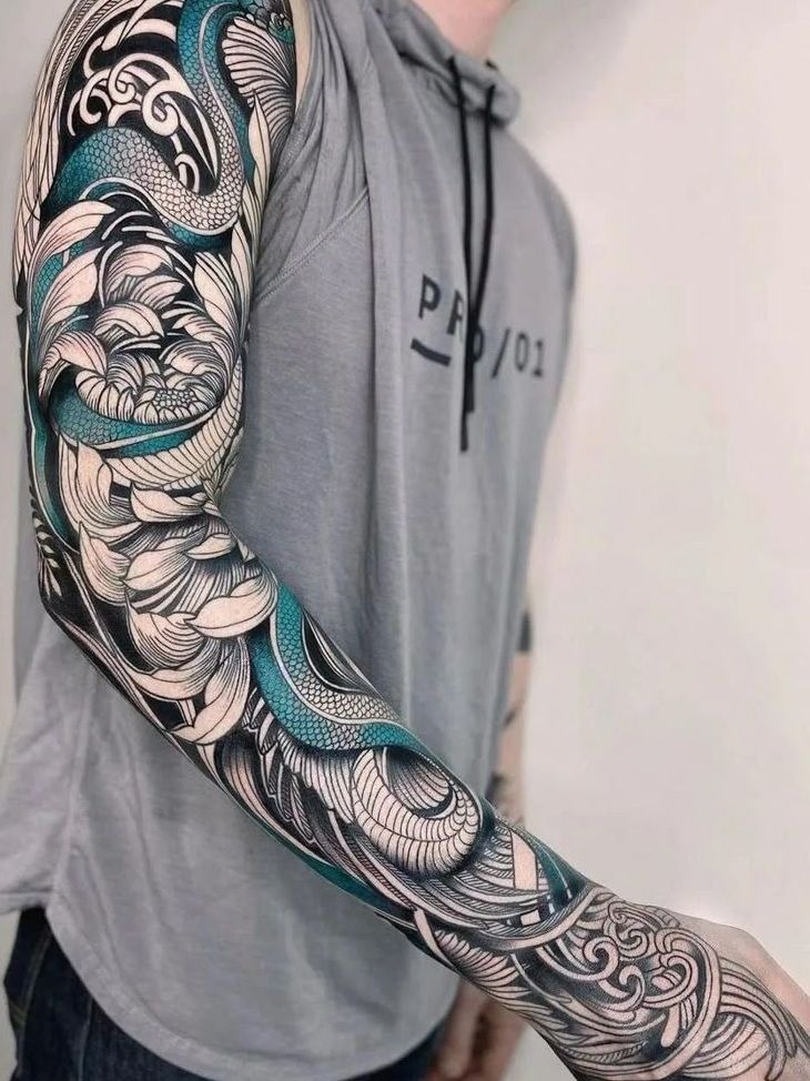 Bold Black and Teal Dragon Sleeve Tattoo Design