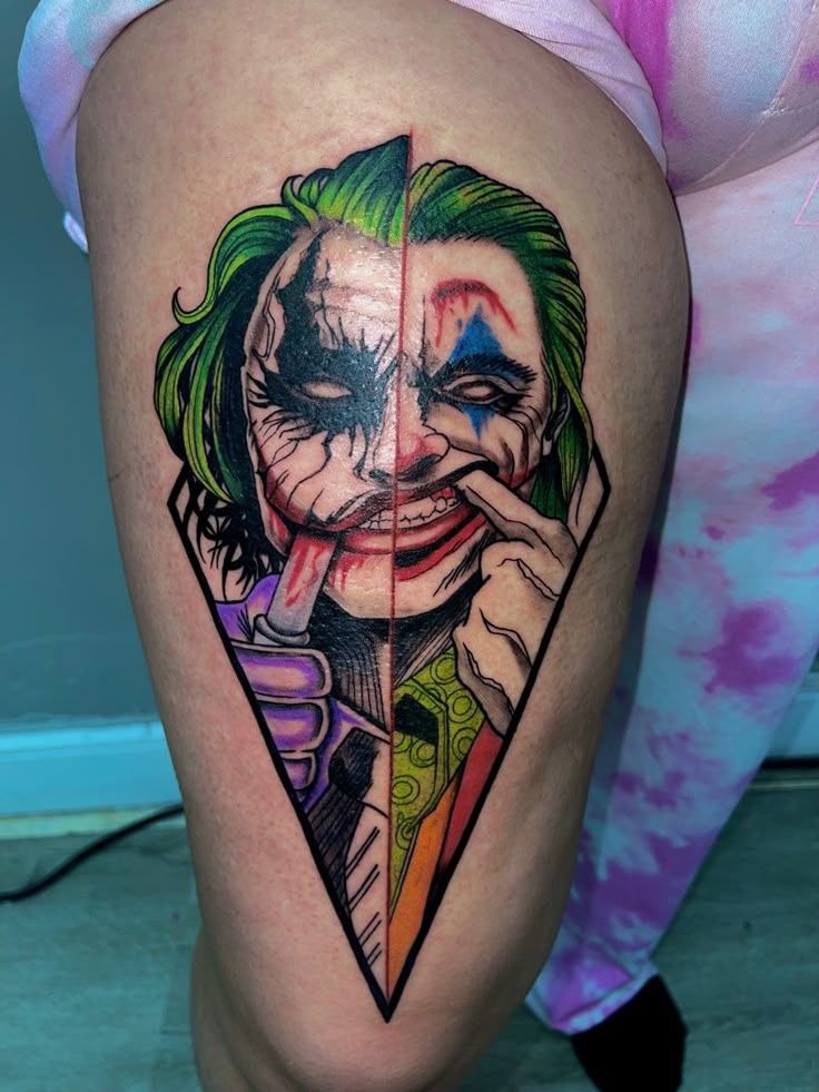Color Split Smile Thigh Tattoo, a tattoo design rendered in bold.