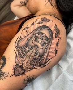 Feminine Santa Muerte Shoulder Tattoo With Roses, a tattoo design rendered in clean detailed linework.