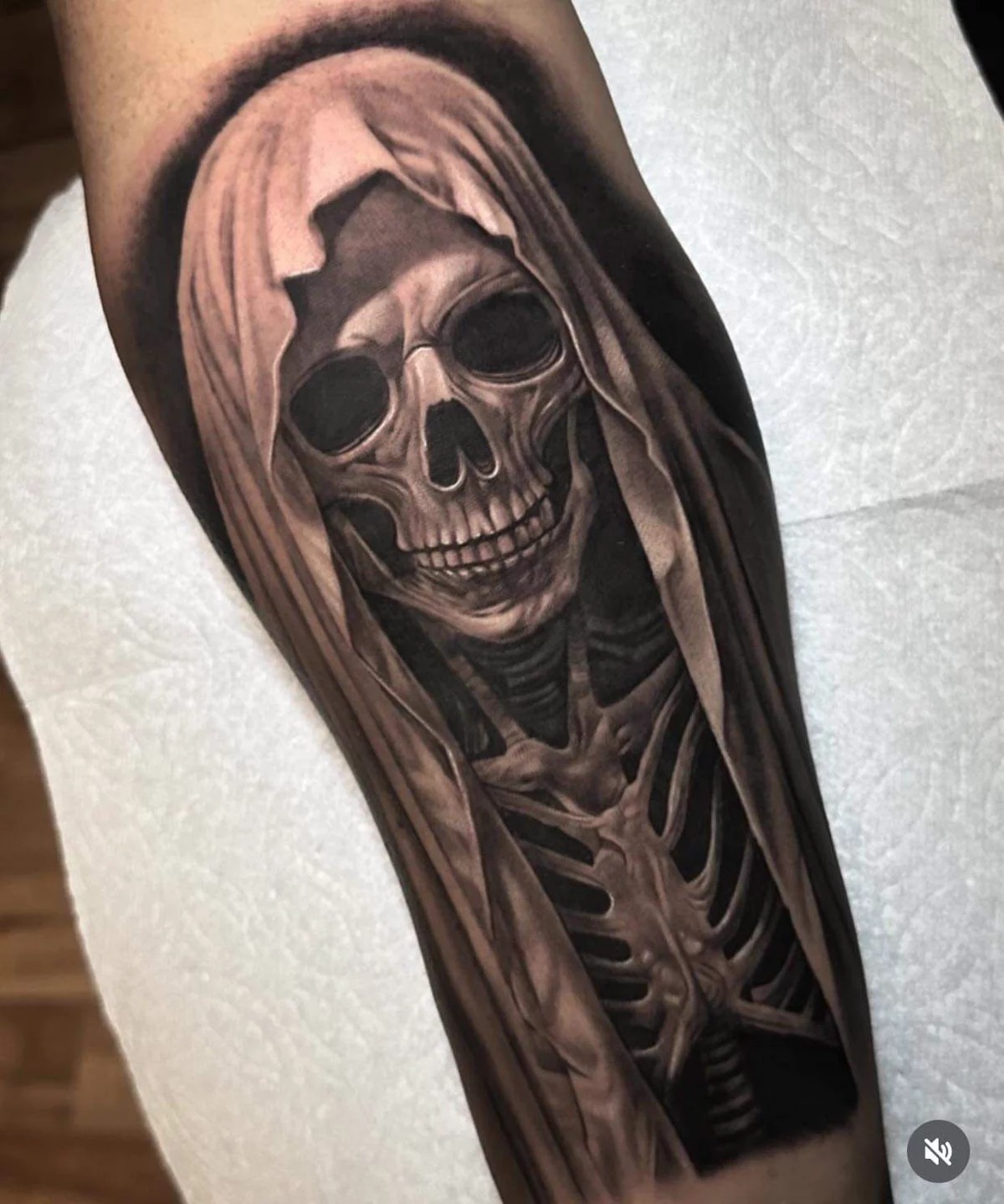 Realistic Hooded Santa Muerte Calf Tattoo, a tattoo design rendered in bold for the ribcage.