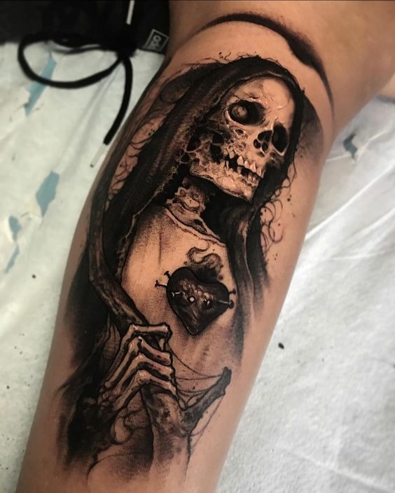 Sacred Heart Santa Muerte Tattoo In Black And Gray, a tattoo design rendered in delicate fine-line for the hand.