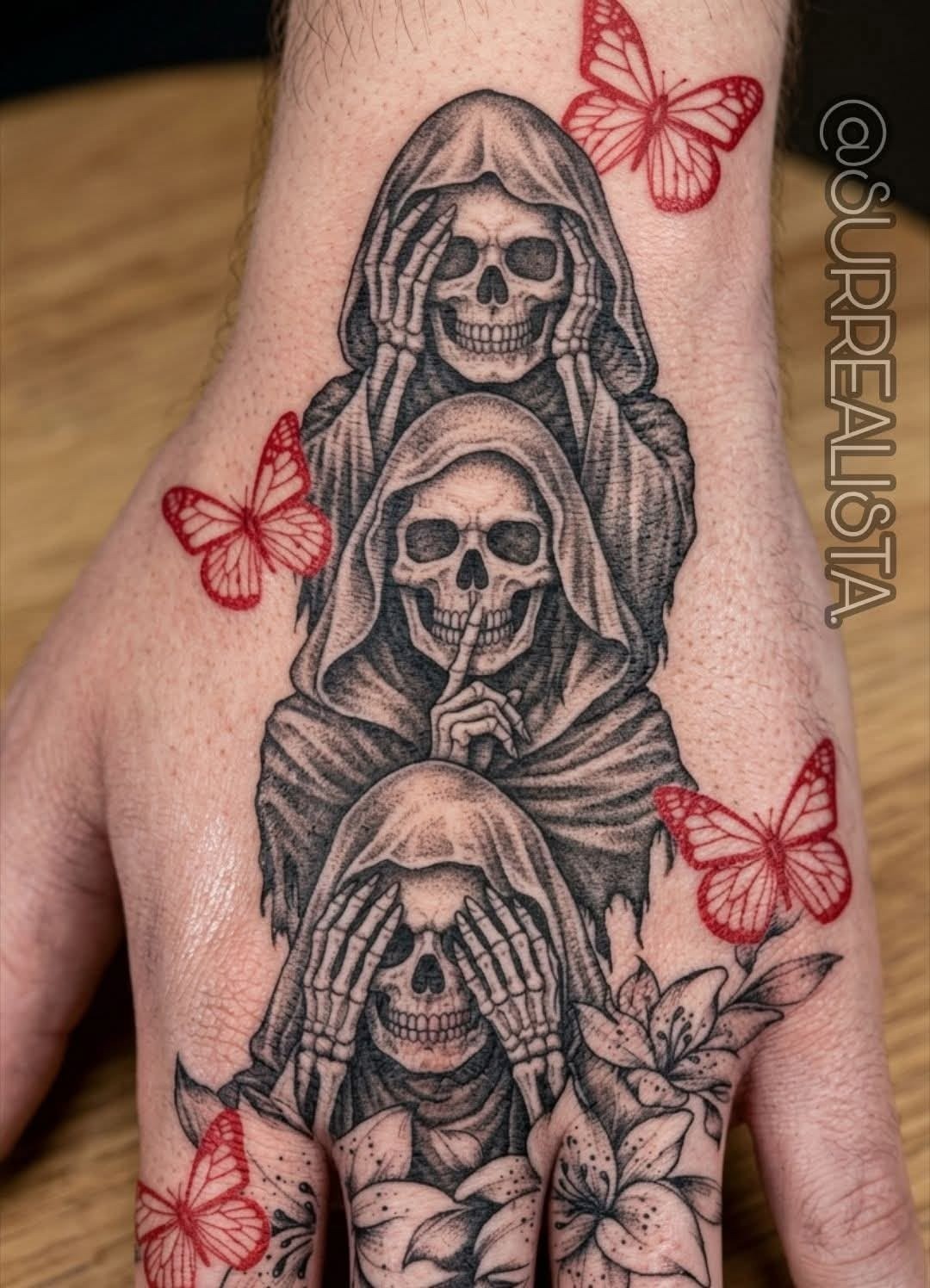 Three Santa Muerte Figures Hand Tattoo With Red Butterflies, a tattoo design rendered in bold.