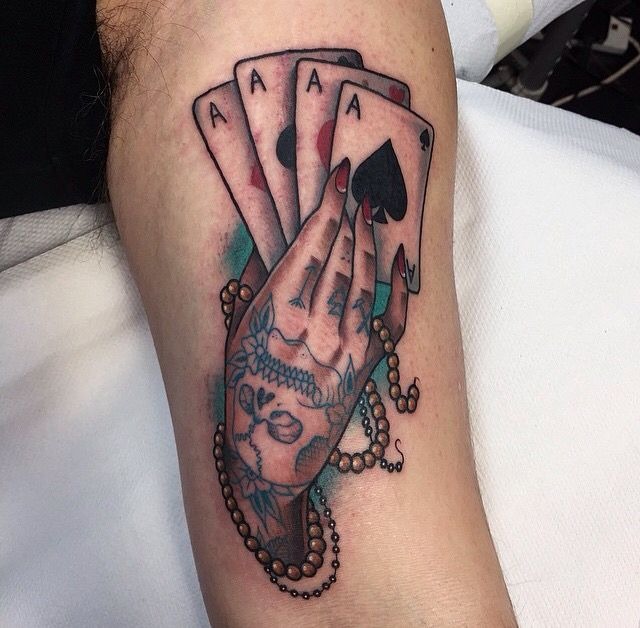 Tattooed Hand Holding Aces Tattoo Design