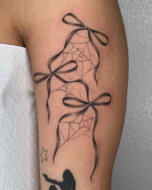 Feminine Bows with Subtle Web Accents Tattoo Design