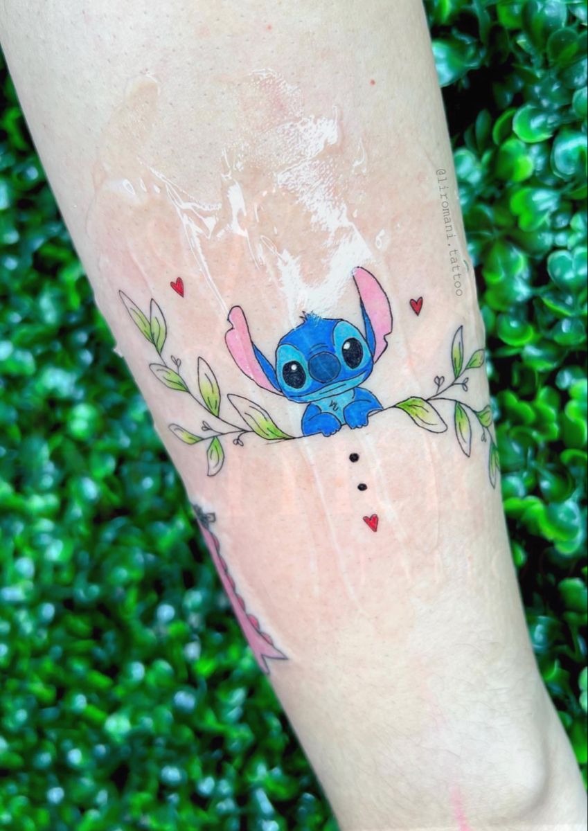 Floral Stitch Peeking Through Branches, a tattoo design rendered in delicate fine-line.