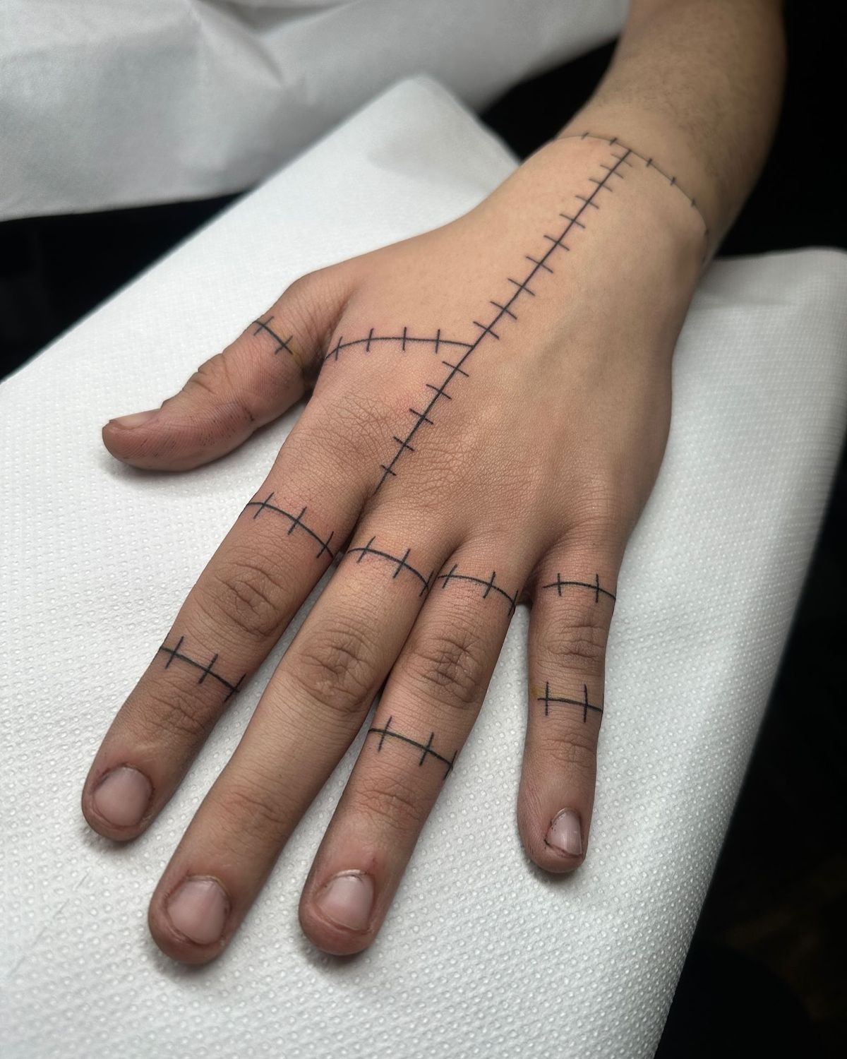 Full Hand-Stitched Pattern, a tattoo design rendered in bold.