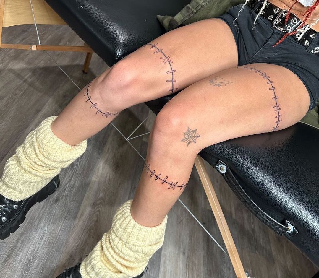Thigh Wrap Stitch Lines Design, a tattoo design rendered in delicate fine-line.