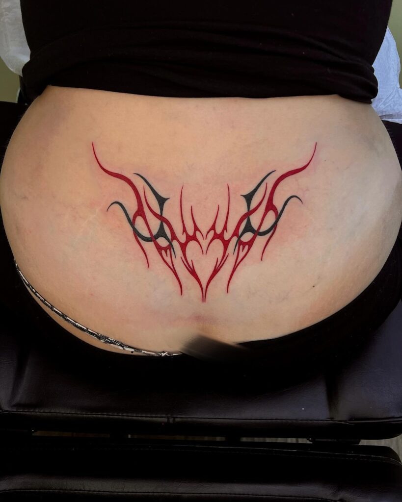 Red and Black Tribal Heart Lower Back Tattoo Tattoo Design